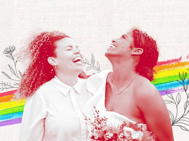 Two women getting married with a rainbow in the back